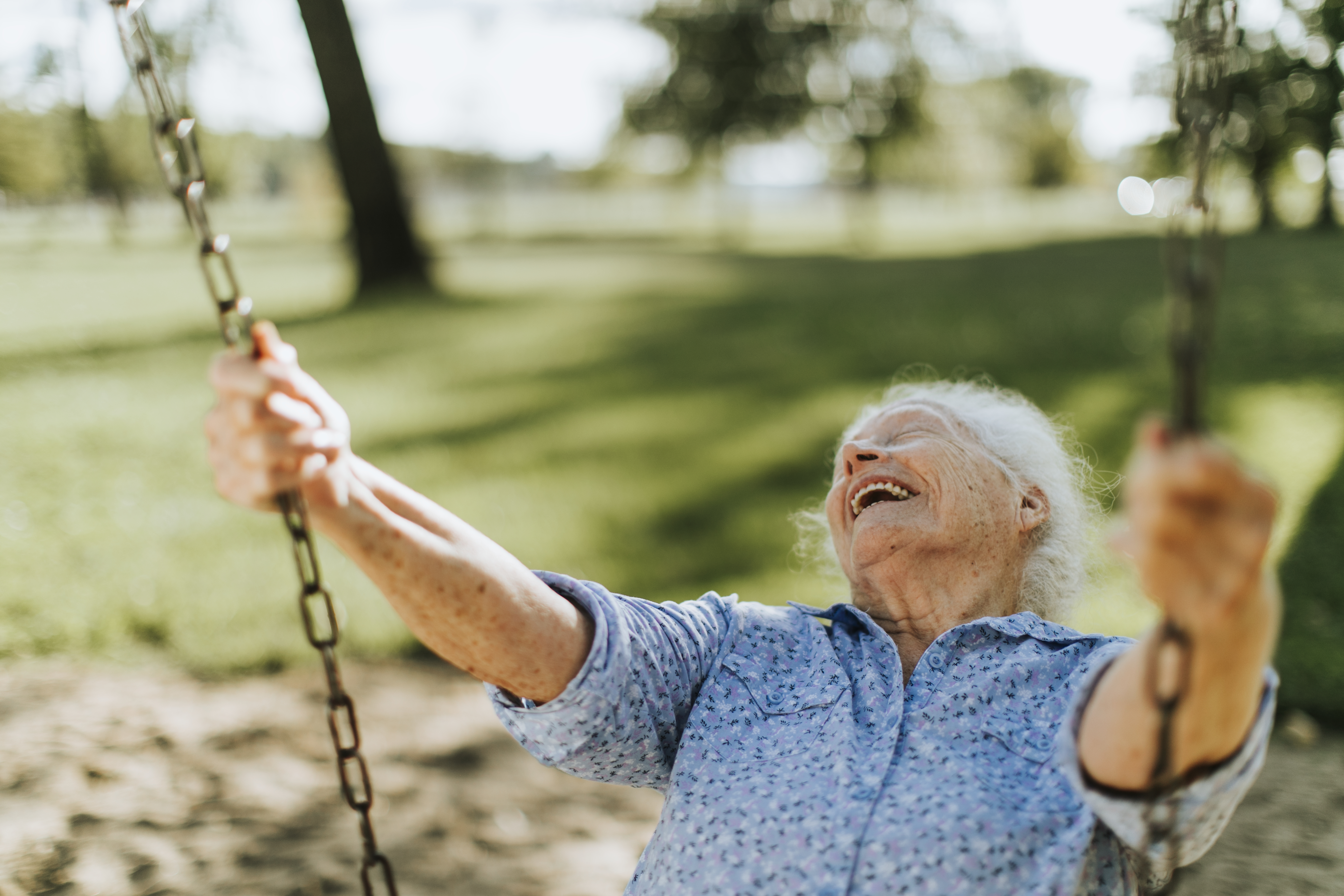 Happy older woman on swing